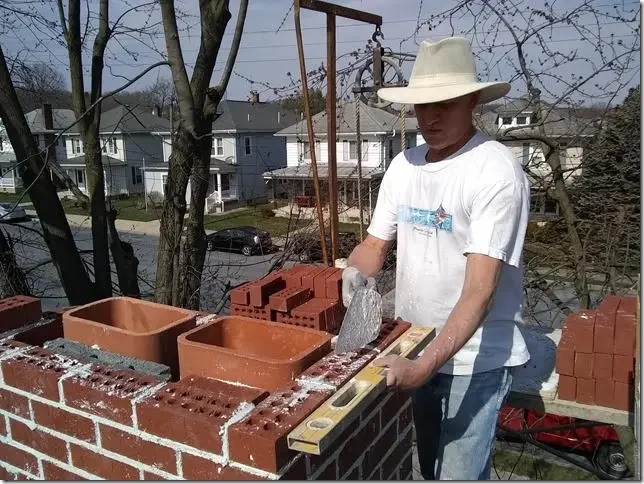 Jeff Grubb finishing a chimney in preparation of installing a chimney cap.